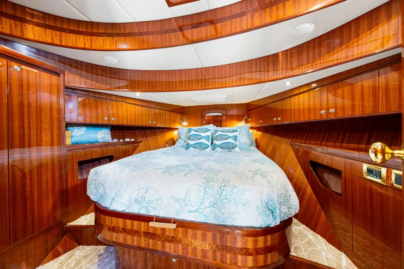 Gypsy Spirit Yacht Photos Pics Luxurious 2007 Hampton 558 Pilothouse yacht bedroom with elegant wood finish and cozy bedding.