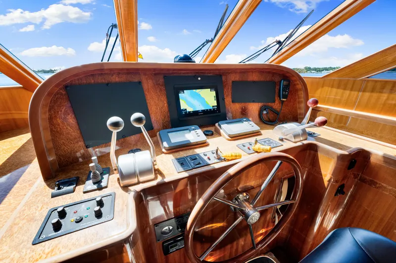 Gypsy Spirit Yacht Photos Pics Pilothouse of 2007 Hampton 558 yacht with navigation equipment and wooden steering wheel.