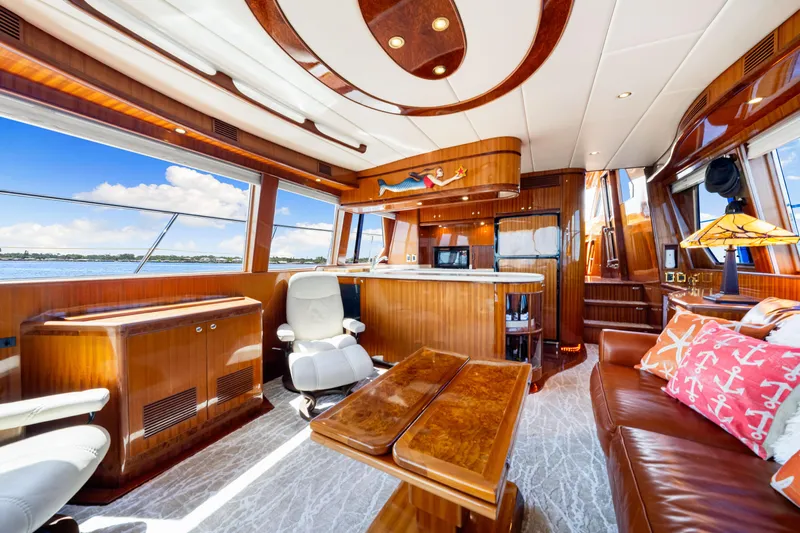 Gypsy Spirit Yacht Photos Pics Luxurious interior of 2007 Hampton 558 Pilothouse yacht with elegant wood finishes and scenic views.