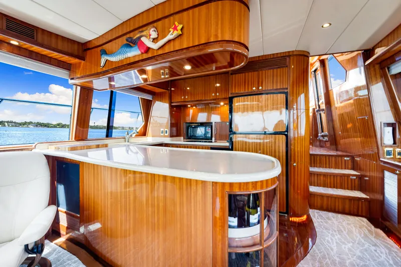 Gypsy Spirit Yacht Photos Pics Luxurious 2007 Hampton 558 Pilothouse yacht interior with elegant wood finishes and modern amenities.