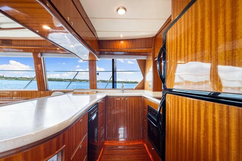Gypsy Spirit Yacht Photos Pics Luxurious 2007 Hampton 558 Pilothouse yacht kitchen with wood finish and ocean view.