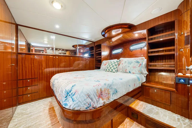 Gypsy Spirit Yacht Photos Pics Luxurious 2007 Hampton 558 Pilothouse yacht bedroom with elegant wood finishes and cozy bedding.