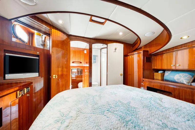 Gypsy Spirit Yacht Photos Pics Luxurious 2007 Hampton 558 Pilothouse yacht bedroom with wood paneling and modern amenities.