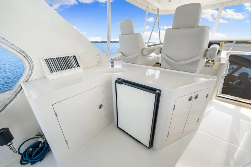 Gypsy Spirit Yacht Photos Pics 2007 Hampton 558 Pilothouse interior with white seating and cabinetry, overlooking the ocean.