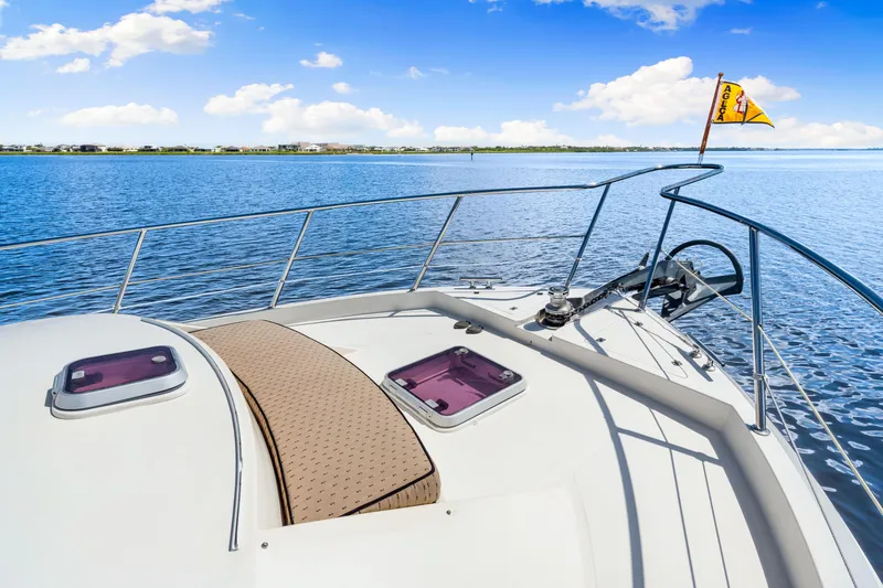 Gypsy Spirit Yacht Photos Pics 2007 Hampton 558 Pilothouse yacht deck with scenic ocean view and clear blue sky.