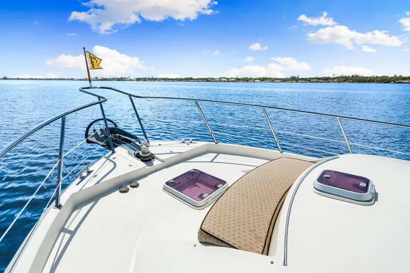 Gypsy Spirit Yacht Photos Pics Bow view of 2007 Hampton 558 Pilothouse yacht on calm blue waters.