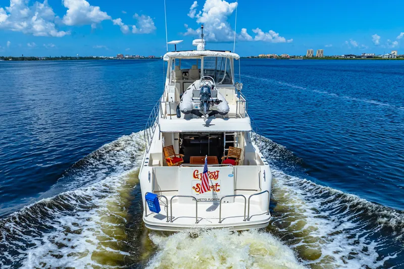Gypsy Spirit Yacht Photos Pics 2007 Hampton 558 Pilothouse yacht cruising on a sunny day with clear blue skies.