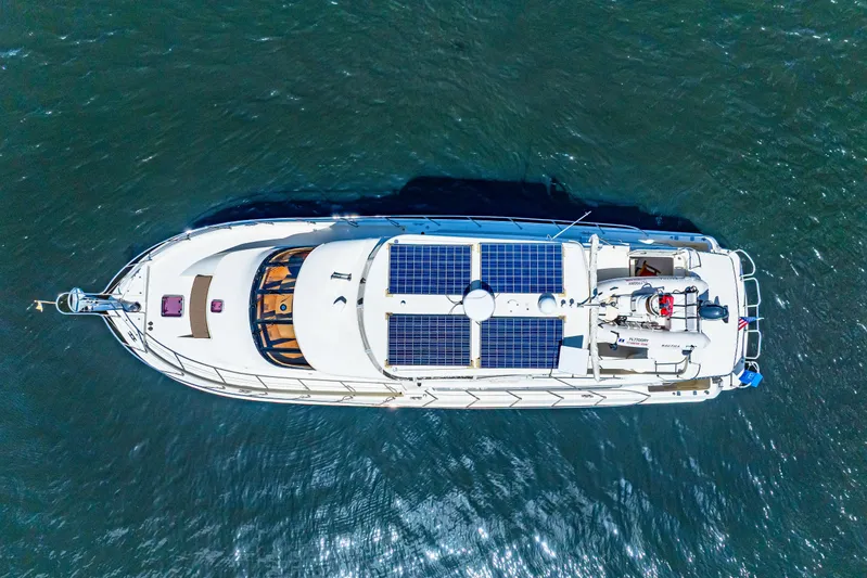 Gypsy Spirit Yacht Photos Pics Aerial view of 2007 Hampton 558 Pilothouse yacht with solar panels on open water.