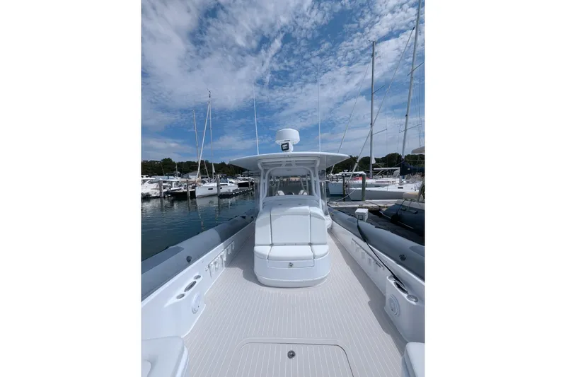 Yellowfin Yacht Photos Pics 2015 Yellowfin RIB boat docked at marina under blue sky.