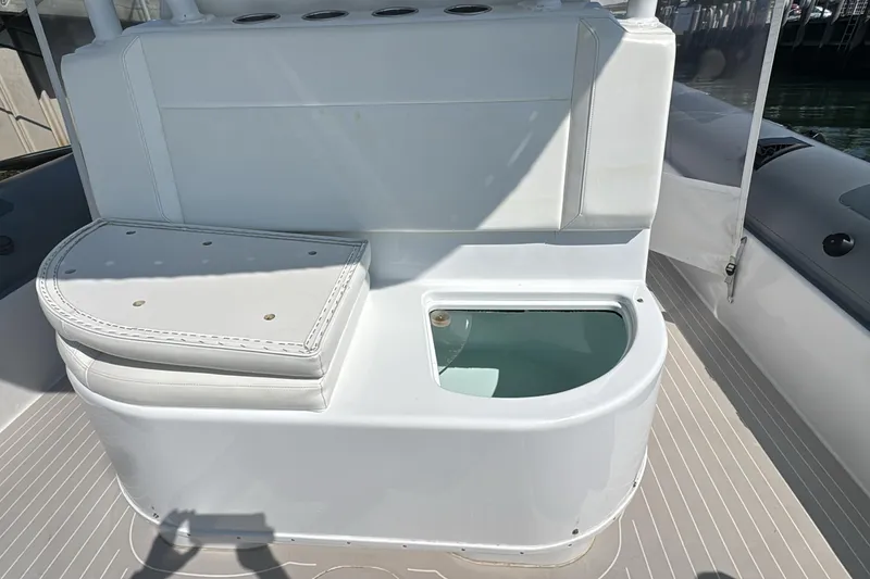 Yellowfin Yacht Photos Pics 2015 Yellowfin RIB boat interior with cushioned seating and storage compartment.
