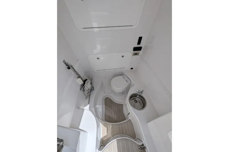 Yellowfin Yacht Photos Pics Interior of 2015 Yellowfin RIB boat featuring compact bathroom with toilet and sink.