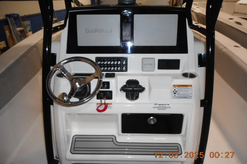  Yacht Photos Pics 2023 Sea Fox 288 Commander boat dashboard with Garmin navigation system and steering wheel.