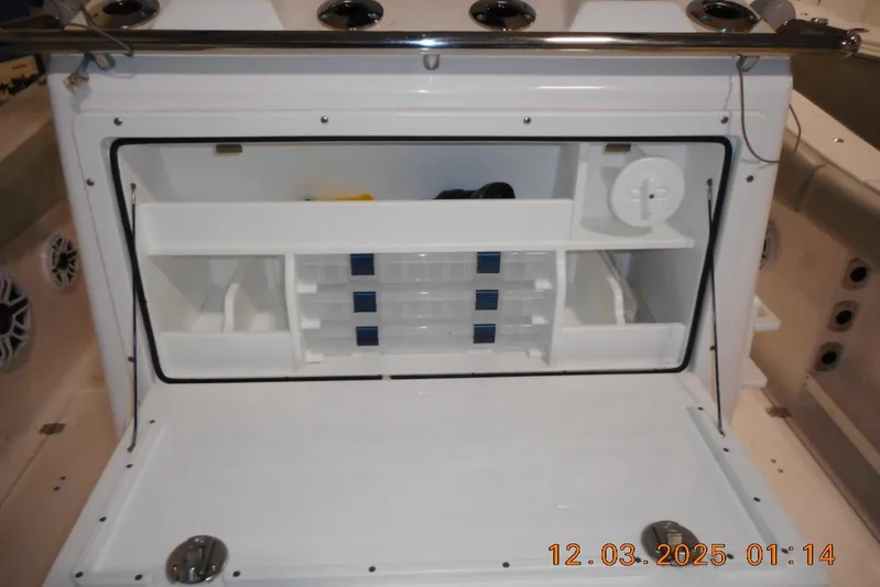  Yacht Photos Pics 2023 Sea Fox 288 Commander boat storage compartment with organized shelves and tackle boxes.