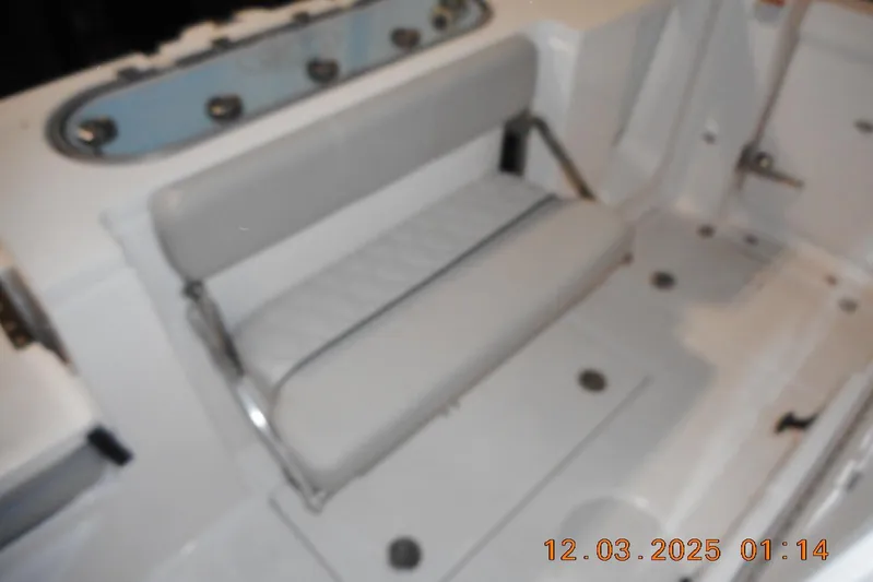  Yacht Photos Pics 2023 Sea Fox 288 Commander boat interior with cushioned seating and storage area.