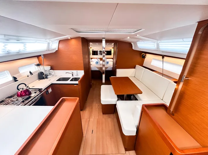 Air Guitar Yacht Photos Pics Interior of 2024 Jeanneau Sun Odyssey 440 yacht, featuring modern kitchen and dining area.
