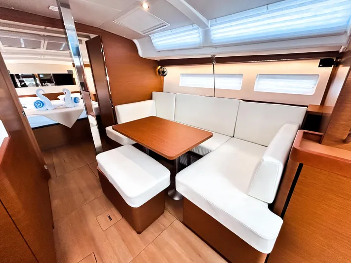 Air Guitar Yacht Photos Pics 2024 Jeanneau Sun Odyssey 440 interior with modern seating and dining area.