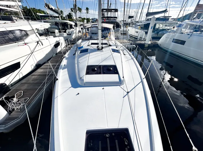 Air Guitar Yacht Photos Pics 2024 Jeanneau Sun Odyssey 440 sailboat docked among other yachts in a marina.