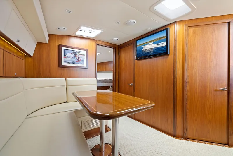 Lil Fella Yacht Photos Pics Interior of 2012 Cabo 44 Hardtop Express yacht with wooden finishes and cozy seating area.