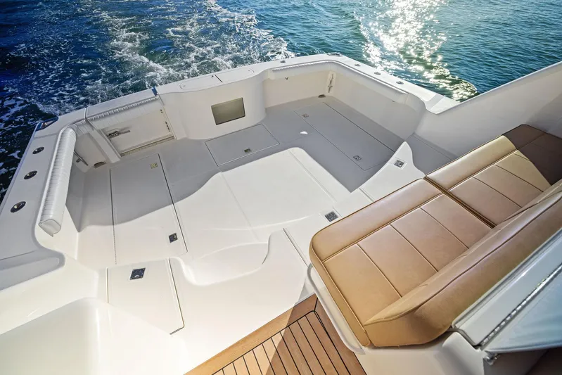 Lil Fella Yacht Photos Pics 2012 Cabo 44 Hardtop Express boat deck with seating and ocean view.
