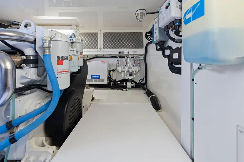 Lil Fella Yacht Photos Pics Engine room of a 2012 Cabo 44 Hardtop Express yacht with various mechanical components.