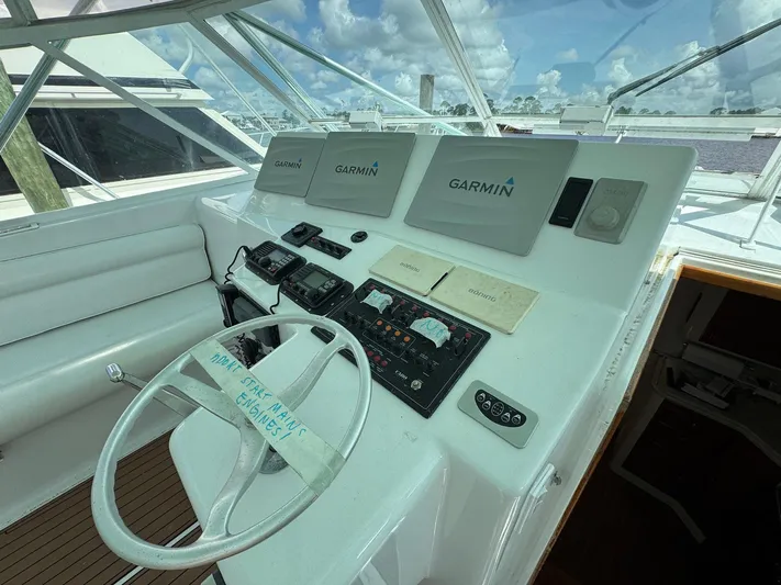  Yacht Photos Pics Helm of 1999 Cabo 45 Express with Garmin navigation displays and steering wheel.