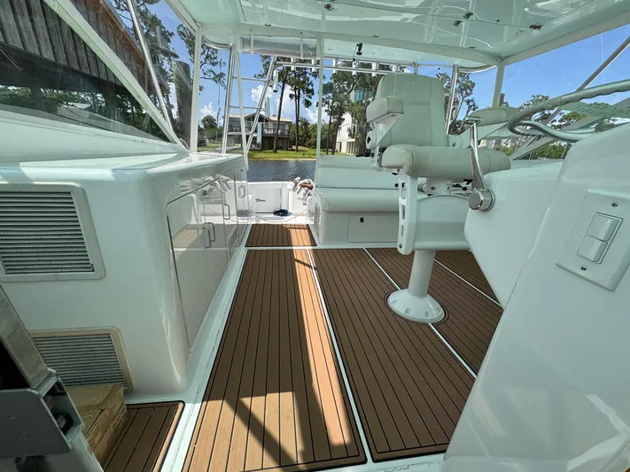  Yacht Photos Pics 1999 Cabo 45 Express boat interior with wooden flooring and white seating.