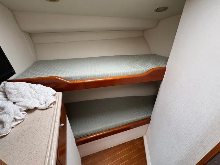  Yacht Photos Pics Bunk beds in 1999 Cabo 45 Express boat cabin with wooden accents.