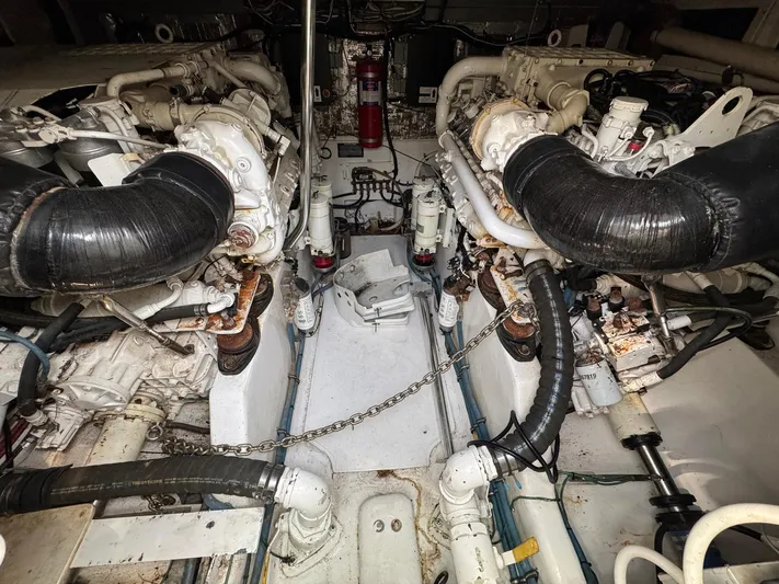  Yacht Photos Pics Engine room of a 1999 Cabo 45 Express boat, featuring dual engines and mechanical components.