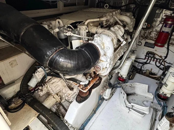  Yacht Photos Pics Engine room of a 1999 Cabo 45 Express boat, showcasing mechanical components and systems.