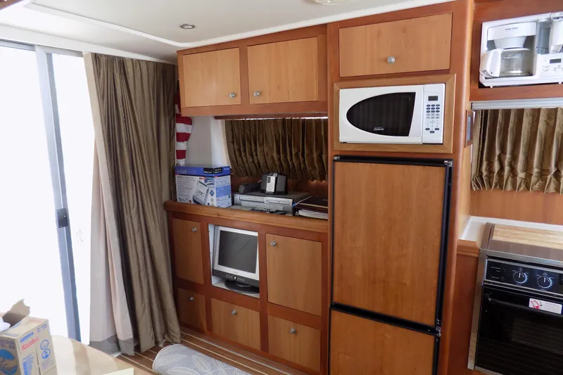  Yacht Photos Pics Interior of 2004 Mainship 390 Trawler with kitchen appliances and wooden cabinetry.