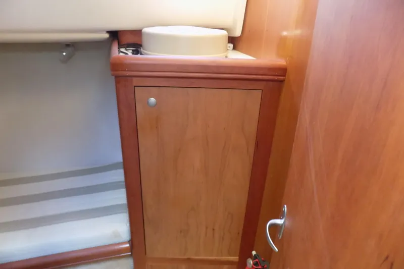  Yacht Photos Pics 2004 Mainship 390 Trawler interior with wooden cabinet and striped flooring.