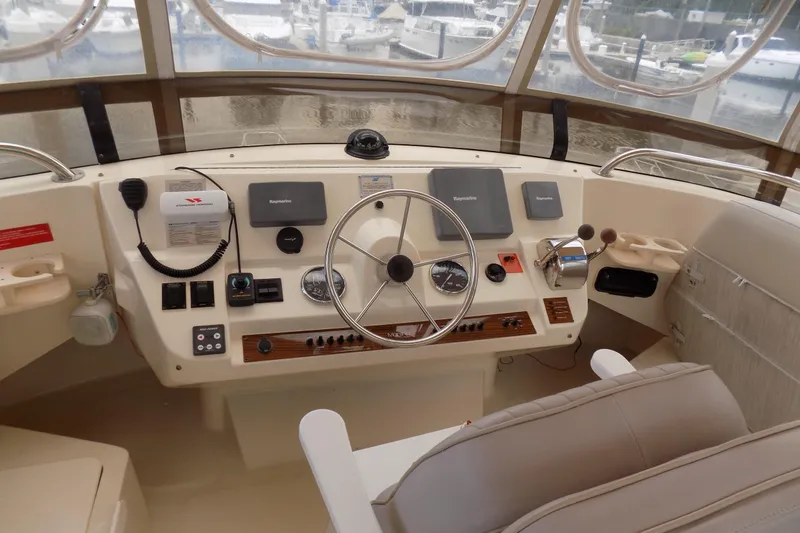  Yacht Photos Pics 2004 Mainship 390 Trawler helm with steering wheel, navigation controls, and gauges.