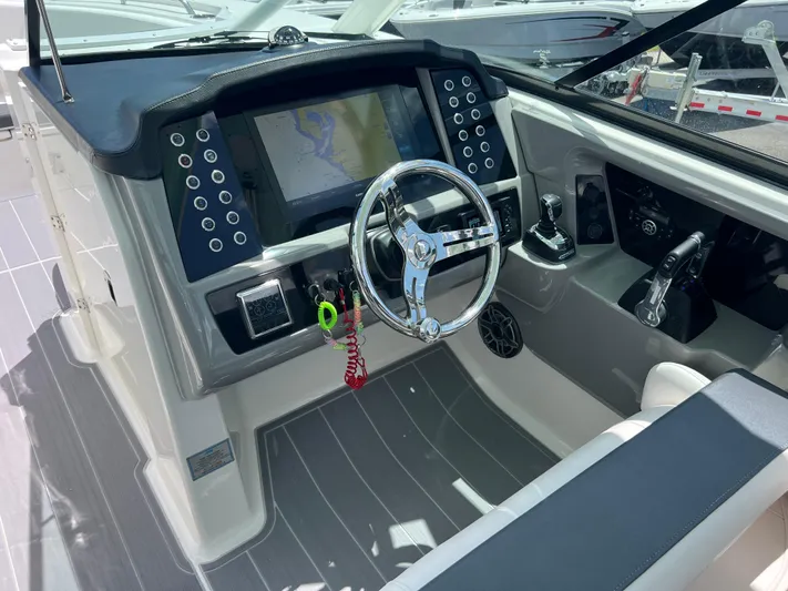  Yacht Photos Pics 2020 Robalo R317 Dual Console boat dashboard with steering wheel and navigation display.