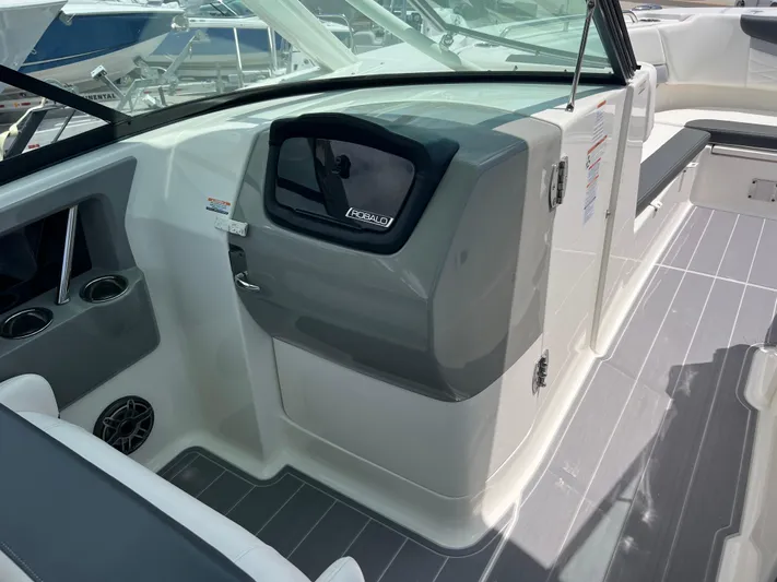  Yacht Photos Pics 2020 Robalo R317 Dual Console boat interior with sleek dashboard and seating area.