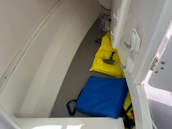  Yacht Photos Pics 2020 Robalo R317 Dual Console interior storage with life jackets and cushions.