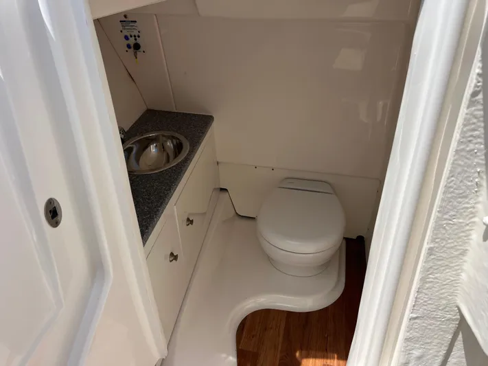  Yacht Photos Pics 2020 Robalo R317 Dual Console boat bathroom with sink and toilet.