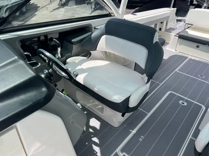  Yacht Photos Pics 2020 Robalo R317 Dual Console boat interior with captain's seat and steering wheel.