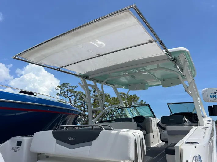  Yacht Photos Pics 2020 Robalo R317 Dual Console boat with canopy, showcasing spacious seating and sleek design.