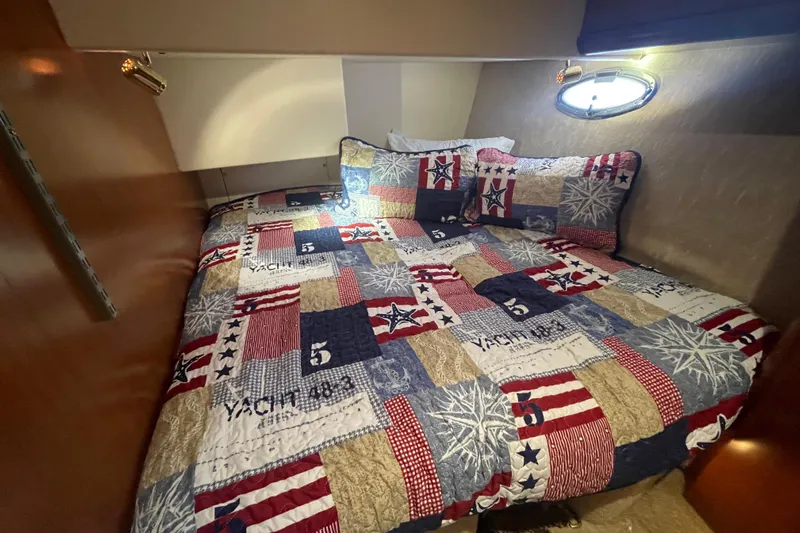 Born Free Yacht Photos Pics Cozy cabin interior of 2007 Silverton 38 Convertible yacht with nautical-themed bedding.
