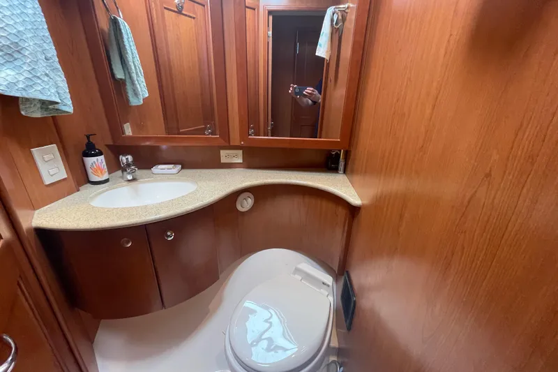 Born Free Yacht Photos Pics Luxurious bathroom in 2007 Silverton 38 Convertible yacht with wood cabinetry and modern fixtures.
