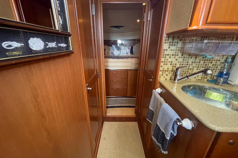 Born Free Yacht Photos Pics 2007 Silverton 38 Convertible yacht interior with wood cabinetry and compact sink area.