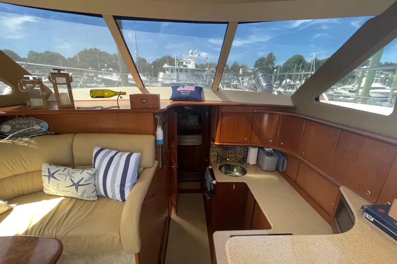 Born Free Yacht Photos Pics Interior of 2007 Silverton 38 Convertible yacht with cozy seating and kitchenette.