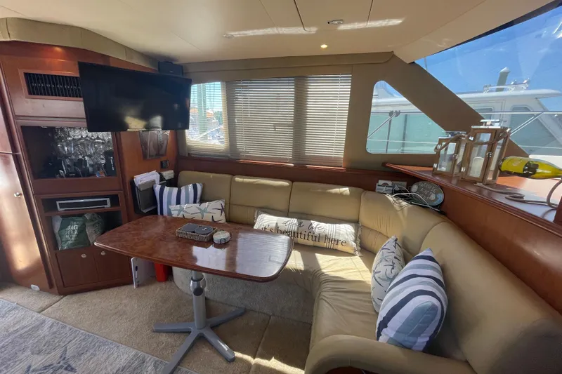 Born Free Yacht Photos Pics Luxurious interior of 2007 Silverton 38 Convertible yacht with cozy seating and elegant decor.