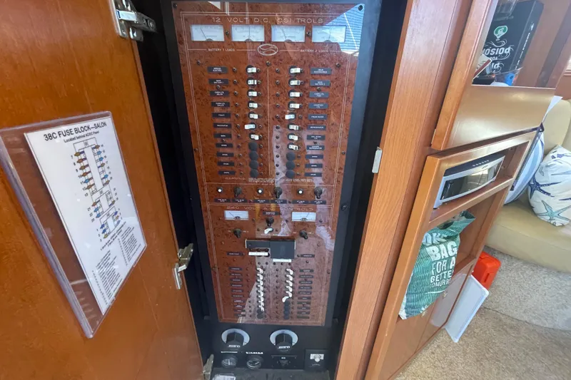 Born Free Yacht Photos Pics Electrical control panel inside 2007 Silverton 38 Convertible yacht, featuring 12V DC controls.