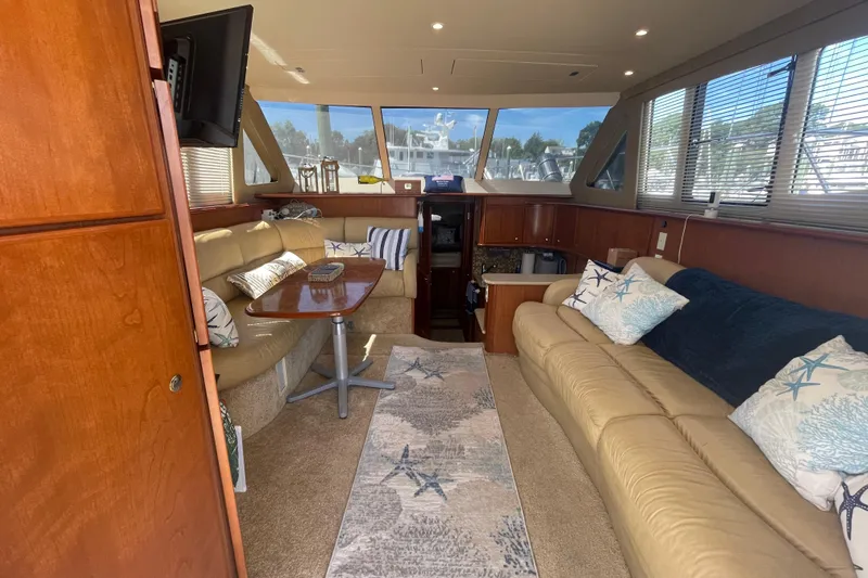Born Free Yacht Photos Pics Luxurious interior of 2007 Silverton 38 Convertible yacht with plush seating and elegant decor.