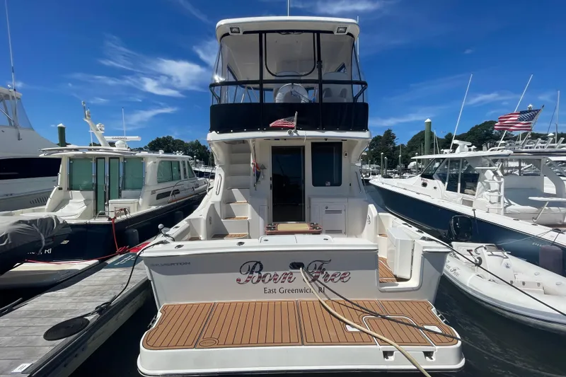 Born Free Yacht Photos Pics 2007 Silverton 38 Convertible yacht docked at marina under clear blue sky.