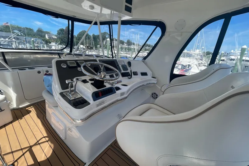Born Free Yacht Photos Pics 2007 Silverton 38 Convertible yacht helm with modern controls and panoramic marina view.