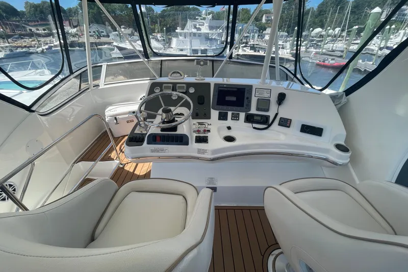 Born Free Yacht Photos Pics 2007 Silverton 38 Convertible yacht helm with modern controls and panoramic marina view.