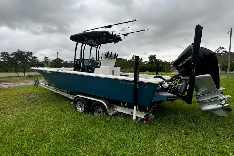  Yacht Photos Pics 2023 Tidewater 2700 Carolina Bay boat on trailer, parked on grass.