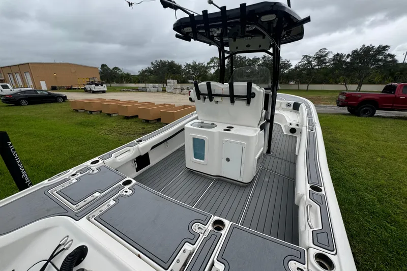  Yacht Photos Pics 2023 Tidewater 2700 Carolina Bay boat with sleek deck design, parked outdoors.